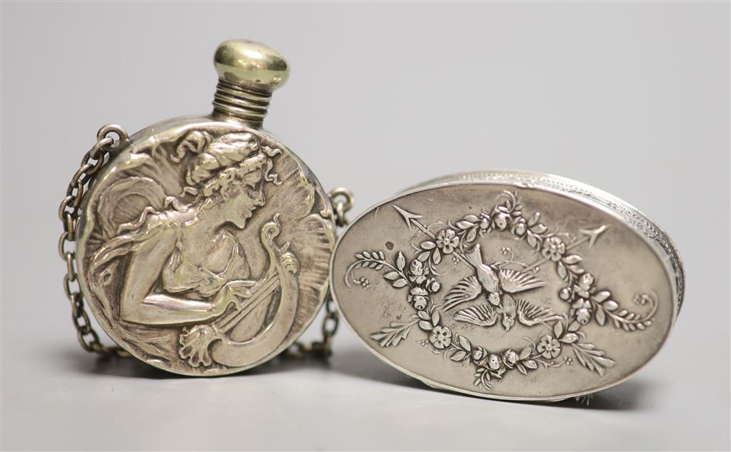 An early 20th century French white metal oval compact, 57mm and a silver plated scent flask.